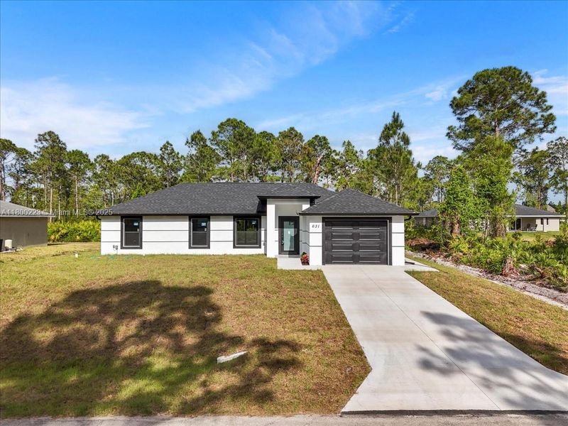 Front exterior of a new home in , Lehigh Acres, FL, highlighting curb appeal (Image 2). Front exterior of a new home in , Lehigh Acres, FL, highlighting curb appeal (Image 2).