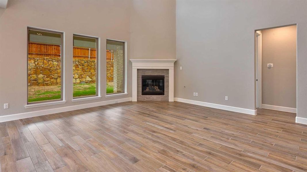 Living room featuring light hardwood / wood-style floors and a high ceiling