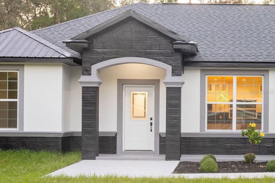 Front exterior of a new home in , Dunnellon, FL, highlighting curb appeal (Image 1). Front exterior of a new home in , Dunnellon, FL, highlighting curb appeal (Image 1).
