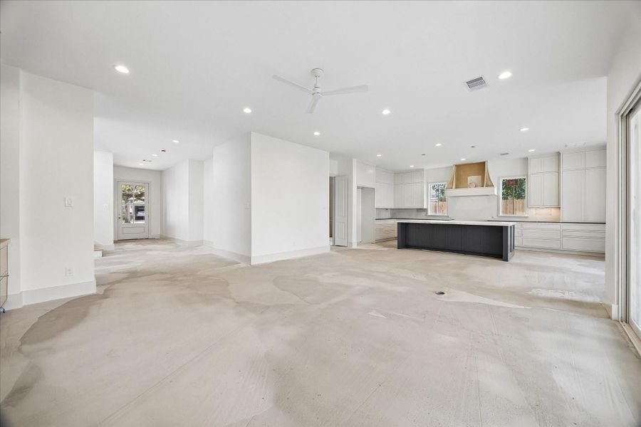 Expansive open concept living space seamlessly connects the living room, dining area, and chef’s kitchen, creating an ideal layout for both everyday living and entertaining.