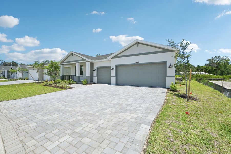 Front exterior of a new home in Hampton Park - Signature Series, Vero Beach, FL, highlighting curb appeal (Image 19).