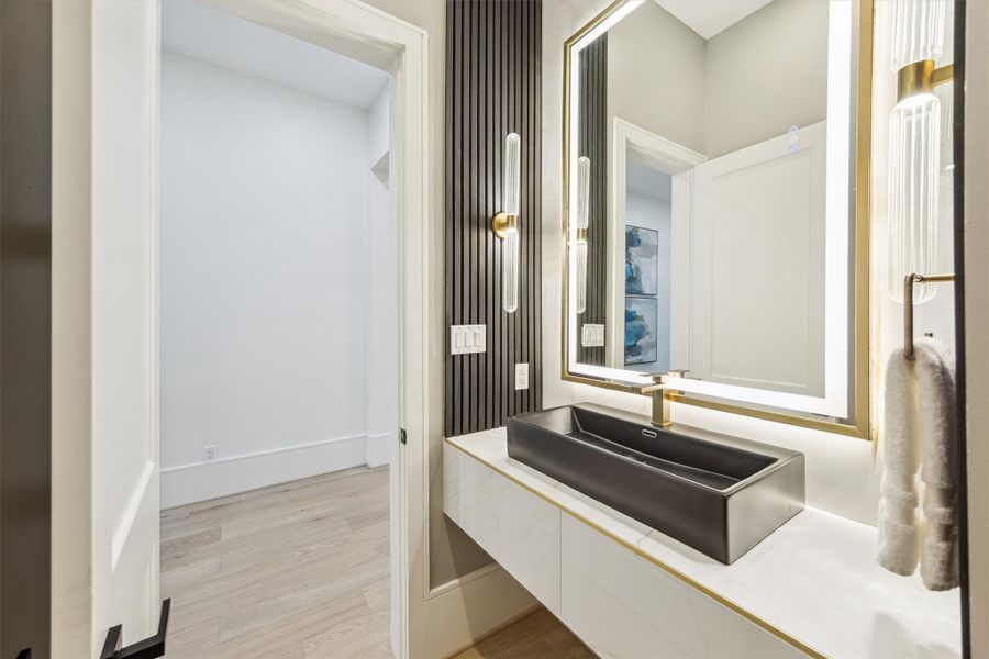 Powder room on the first floor - with dramatic chevron-patterned accent walls and a floating vanity.