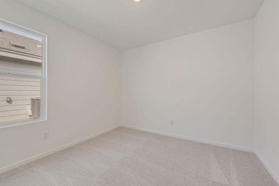 Unfurnished room with light carpet and baseboards