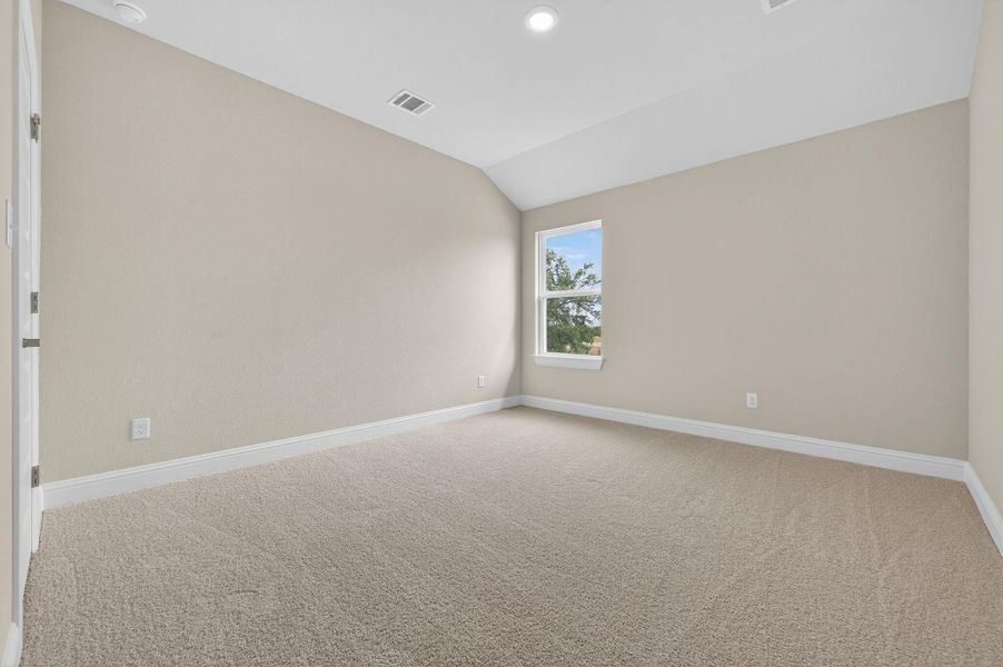 Spare room featuring lofted ceiling, light colored carpet, and recessed lighting