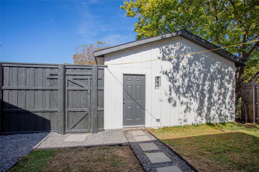 View of outbuilding featuring a yard