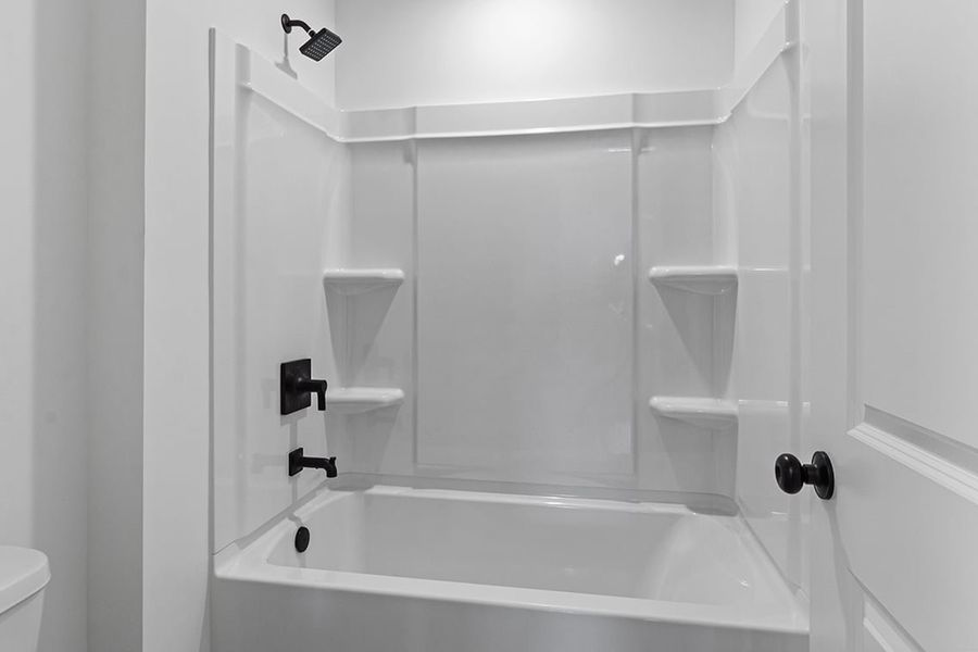 A bathtub with a glass door.