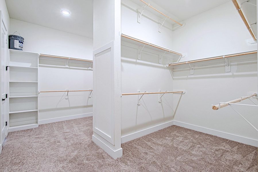 Expansive walk-in closet within the primary suite offering generous storage