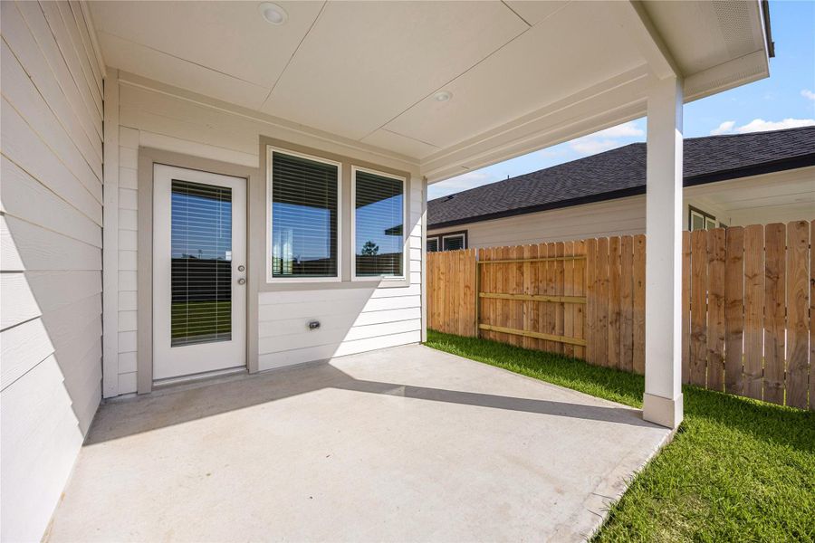 Enjoy outdoor living on the covered patio overlooking the fenced backyard, ideak for relaxing, grilling, or entertaining with family and friends.