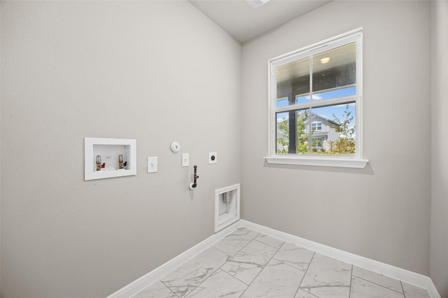 Tiled flooring and a large window bring functional style to this dedicated utility space. Tiled flooring and a large window bring functional style to this dedicated utility space.