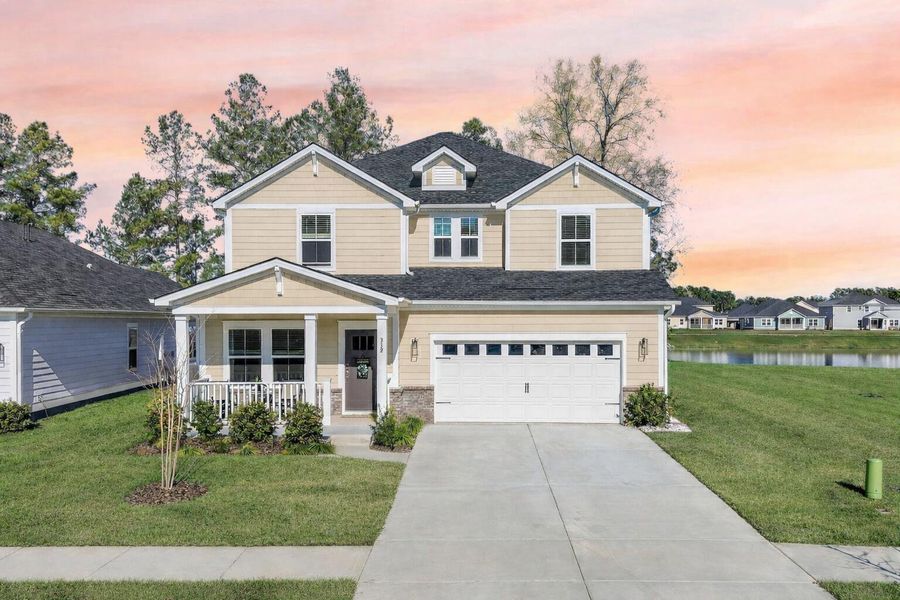 Front exterior of a new home in The Coves at Lakes of Cane Bay, Summerville, SC, highlighting curb appeal (Image 1). Front exterior of a new home in The Coves at Lakes of Cane Bay, Summerville, SC, highlighting curb appeal (Image 1).