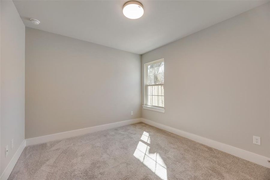 Spare room with light colored carpet