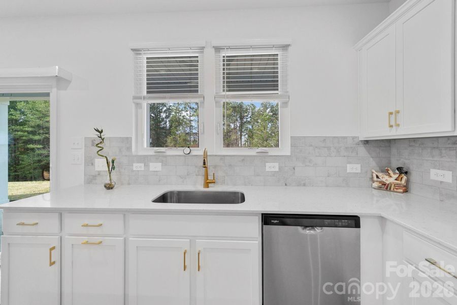Kitchen with White Cabinetry and Stainless Steel Appliances