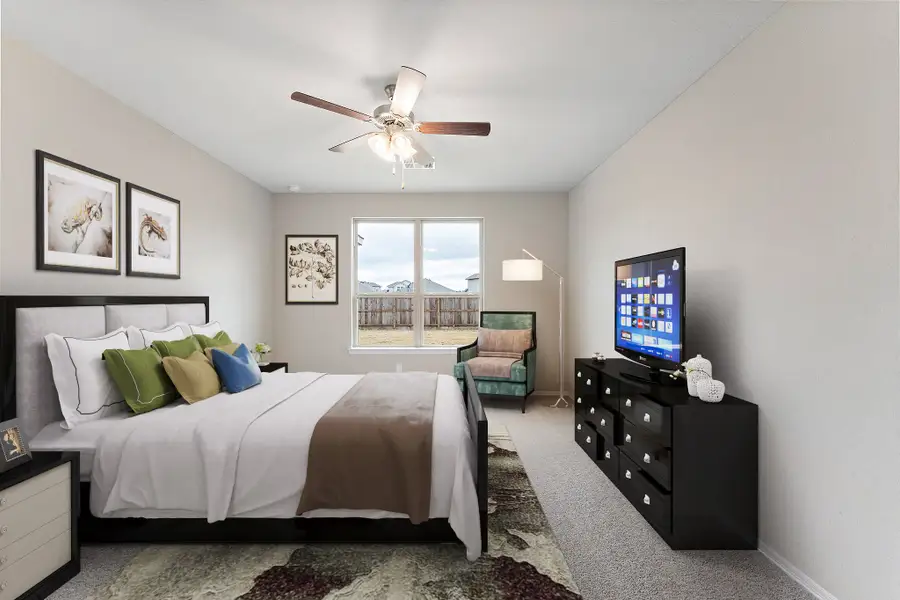 A bedroom with a large window.