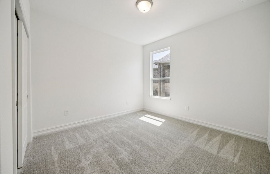 Spacious secondary bedroom with expansive windows Spacious secondary bedroom with expansive windows