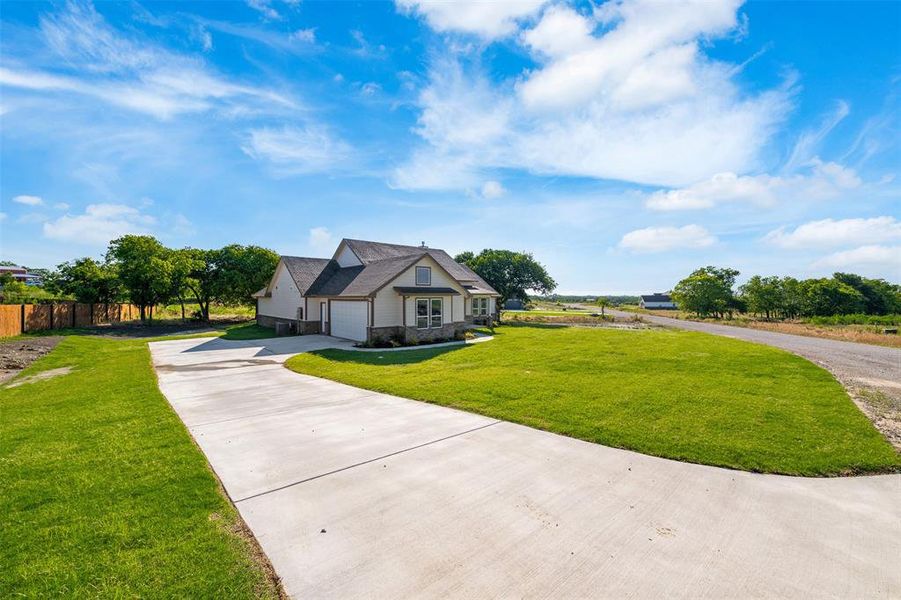View of front of property featuring driveway and a garage View of front of property featuring driveway and a garage