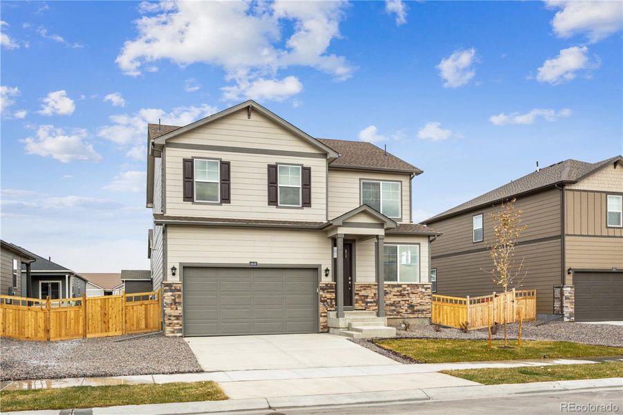 Front exterior of a new home in Ridge at Johnstown, Johnstown, CO, highlighting curb appeal (Image 1).