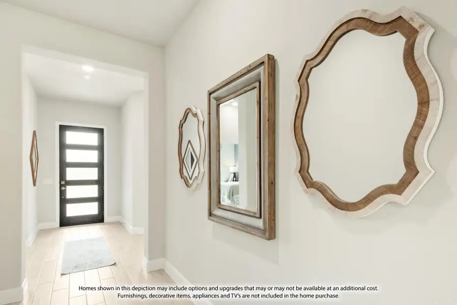 Bright entryway hallway with decorative wood-framed mirrors on white walls and a modern black front door Bright entryway hallway with decorative wood-framed mirrors on white walls and a modern black front door