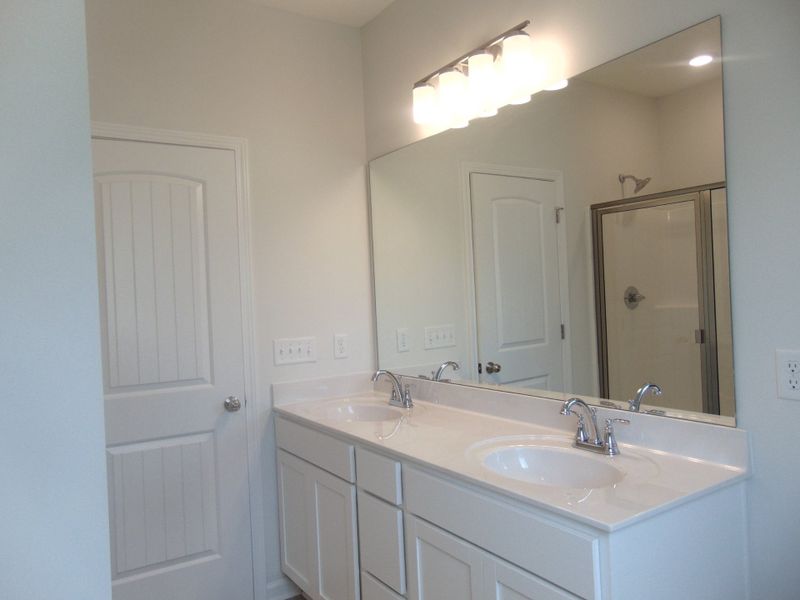 The primary bathroom comes with a two sink, soaking bath tub, shower, and an elongated toilet. The primary bathroom comes with a two sink, soaking bath tub, shower, and an elongated toilet.