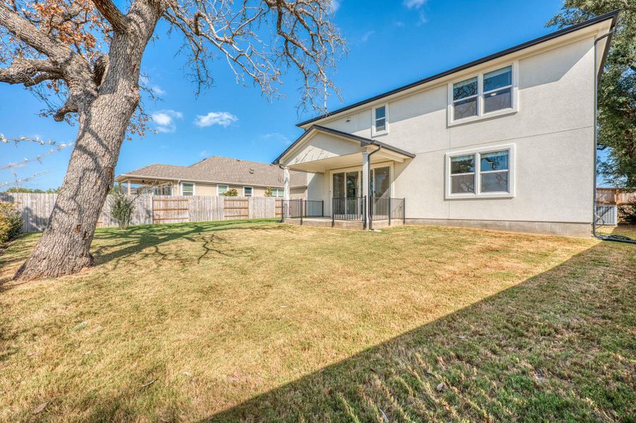 Mature trees shade a spacious lawn bordering the stucco exterior of this multi-level home. Mature trees shade a spacious lawn bordering the stucco exterior of this multi-level home.
