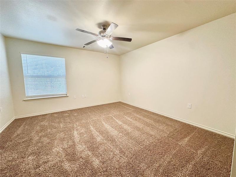 Unfurnished room with ceiling fan and carpet flooring