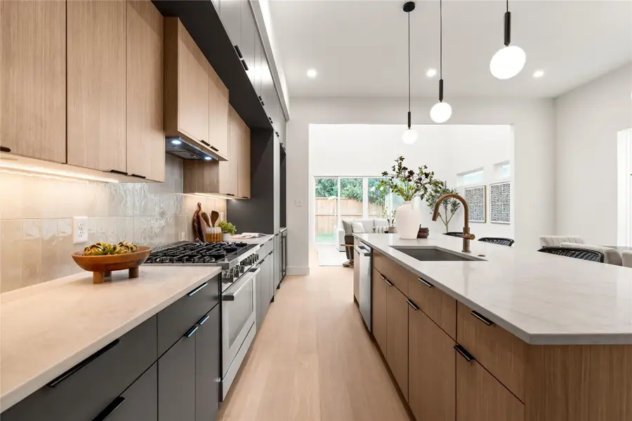 This oversized kitchen features luxury Bosch appliances, Taj Mahal counters, and more than enough storage space with three layers of European soft close cabinetry. This oversized kitchen features luxury Bosch appliances, Taj Mahal counters, and more than enough storage space with three layers of European soft close cabinetry.