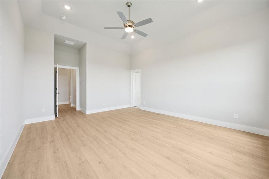 Unfurnished bedroom with light wood-style flooring, a ceiling fan, and recessed lighting