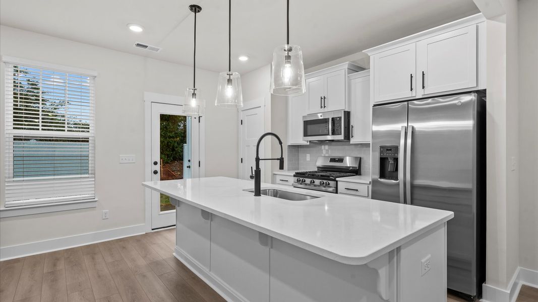 Notable 9-foot island provides generous prep and gathering space in this thoughtfully designed kitchen