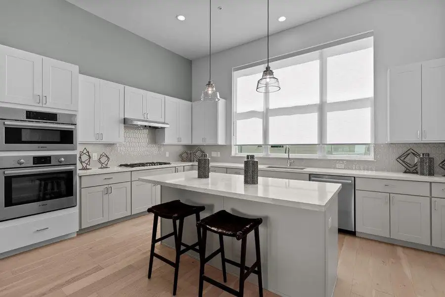 Smooth wood floors and crisp countertops define this contemporary culinary space. Smooth wood floors and crisp countertops define this contemporary culinary space.
