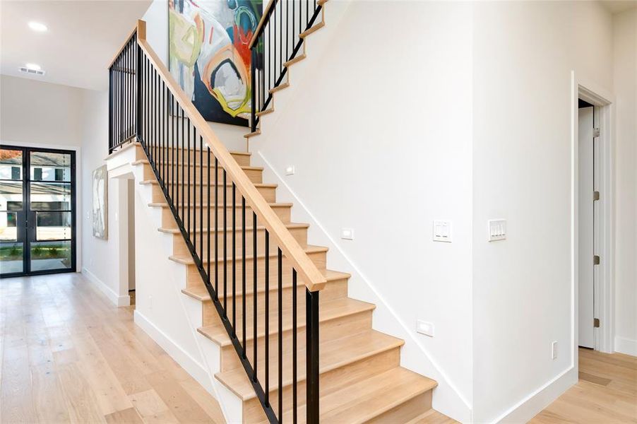 Staircase with hardwood / wood-style flooring