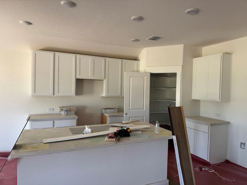 Kitchen with a center island and white cabinets