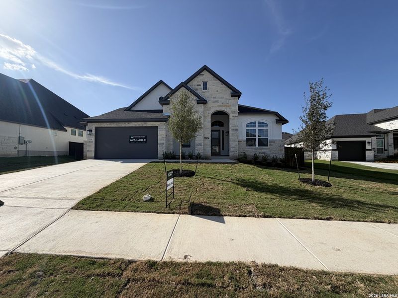 Front exterior of a new home in Mesa Western, Cibolo, TX, highlighting curb appeal (Image 1). Front exterior of a new home in Mesa Western, Cibolo, TX, highlighting curb appeal (Image 1).