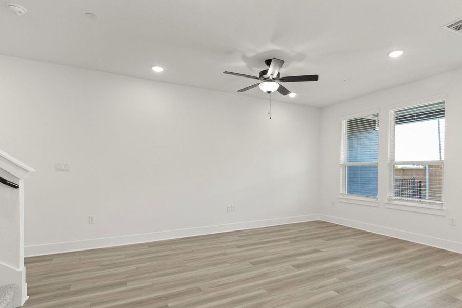 Spare room featuring light wood finished floors, recessed lighting, and a ceiling fan
