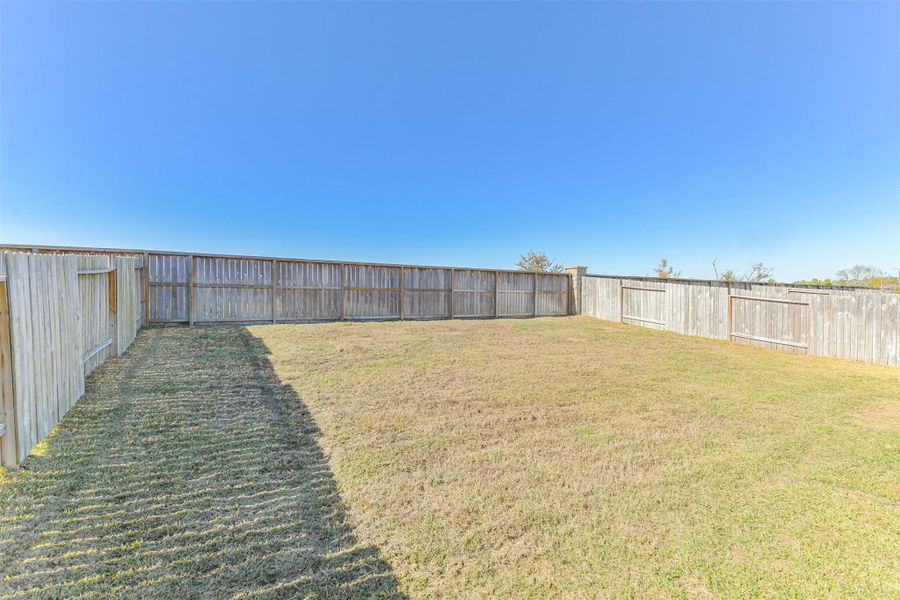Exterior details and patio area of a home in Harrington Trails at The Canopies, New Caney (Image 24).