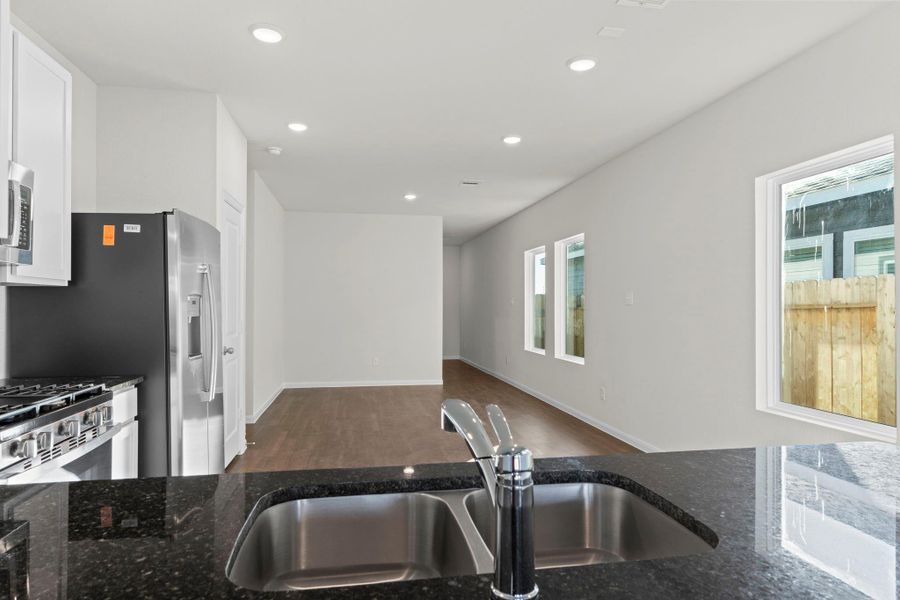 View from the kitchen overlooking the dining and living areas—designed for effortless entertaining and connection! Refrigerator, washer, and dryer are all included for move-in-ready convenience. View from the kitchen overlooking the dining and living areas—designed for effortless entertaining and connection! Refrigerator, washer, and dryer are all included for move-in-ready convenience.