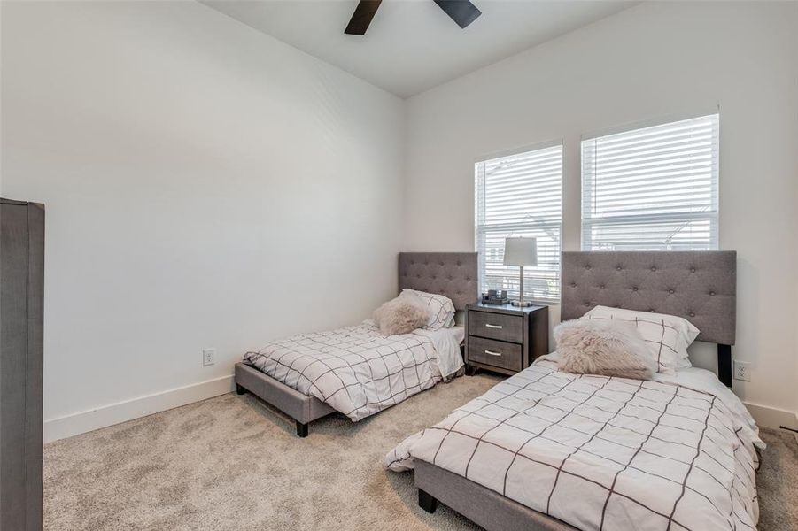 Bedroom featuring ceiling fan and light colored carpet