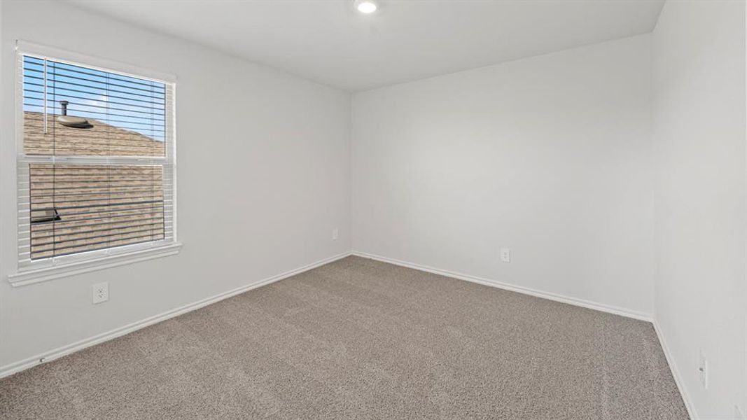 Carpeted spare room featuring baseboards and recessed lighting