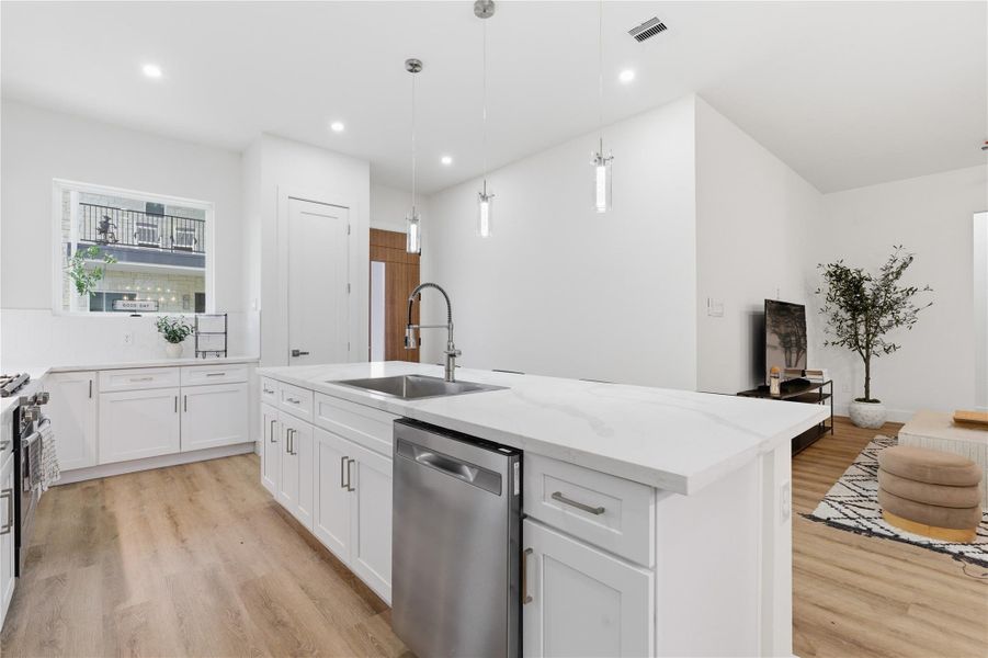 A chef-inspired kitchen anchors the space with an oversized quartz island, stainless steel appliances, and seamless flow into the living area - perfect for everyday living and entertaining.