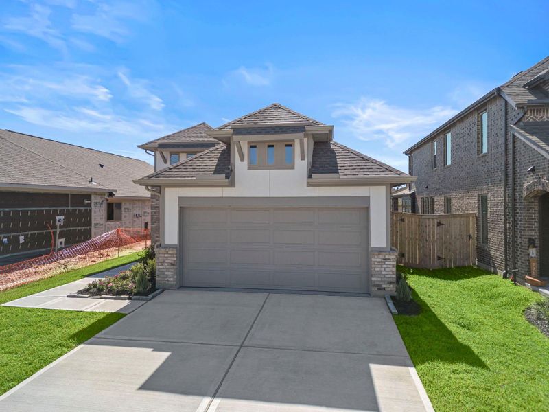 Front exterior of a new home in Grand Central Park, Conroe, TX, highlighting curb appeal (Image 2). Front exterior of a new home in Grand Central Park, Conroe, TX, highlighting curb appeal (Image 2).