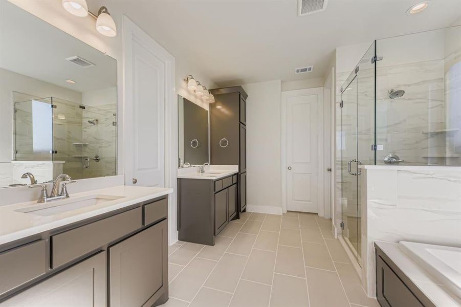 Full bathroom with two vanities, a marble finish shower, light tile patterned flooring, recessed lighting, and a bath