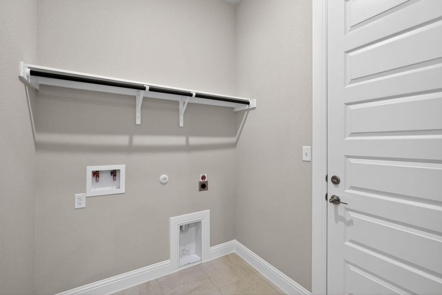 Laundry area with gas dryer hookup, electric dryer hookup, and washer hookup Laundry area with gas dryer hookup, electric dryer hookup, and washer hookup