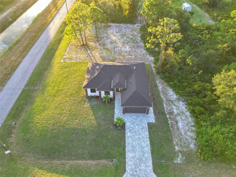 Front exterior of a new home in , Lehigh Acres, FL, highlighting curb appeal (Image 1).