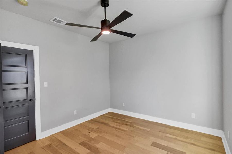 Unfurnished room with light wood-style floors and ceiling fan