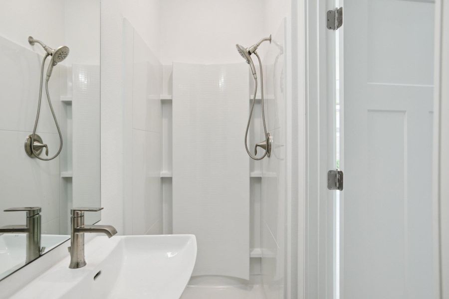 Bathroom with a shower stall and a sink