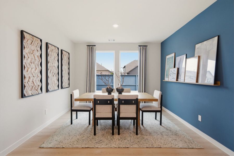 A dining room with a table and chairs. A dining room with a table and chairs.