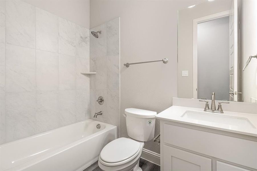 Full bathroom featuring tub / shower combination and vanity Full bathroom featuring tub / shower combination and vanity