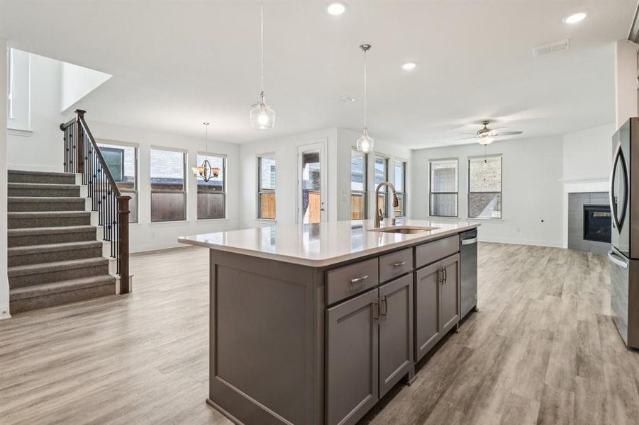 Kitchen featuring recessed lighting, decorative light fixtures, open floor plan, light wood-style flooring, and healthy amount of natural light Kitchen featuring recessed lighting, decorative light fixtures, open floor plan, light wood-style flooring, and healthy amount of natural light