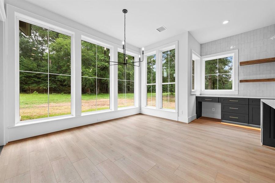 Floor to ceiling cased windows in breakfast area.