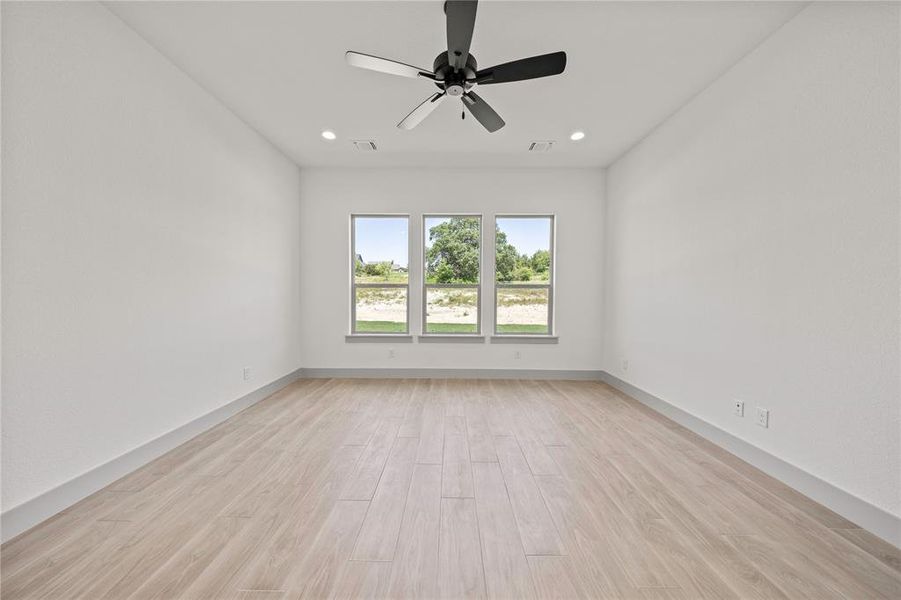 Spare room with light wood finished floors, recessed lighting, and a ceiling fan Spare room with light wood finished floors, recessed lighting, and a ceiling fan