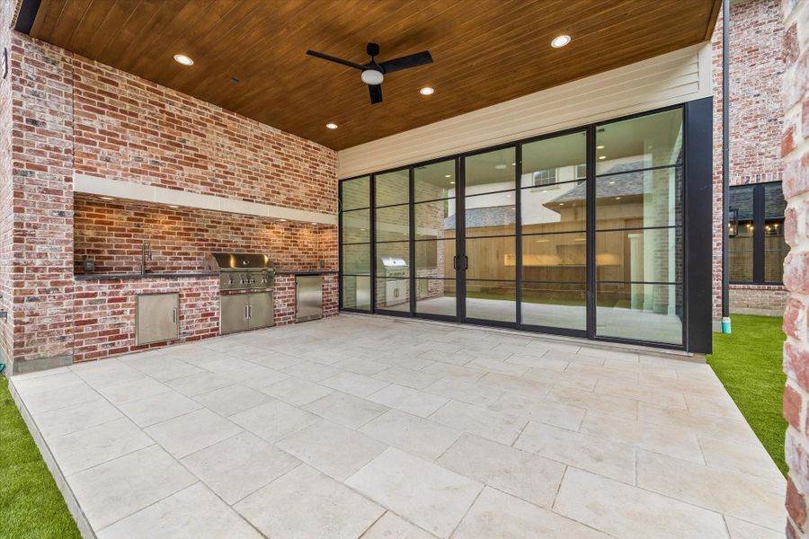 Covered outdoor kitchen to included gas grill and beverage refrigerator.