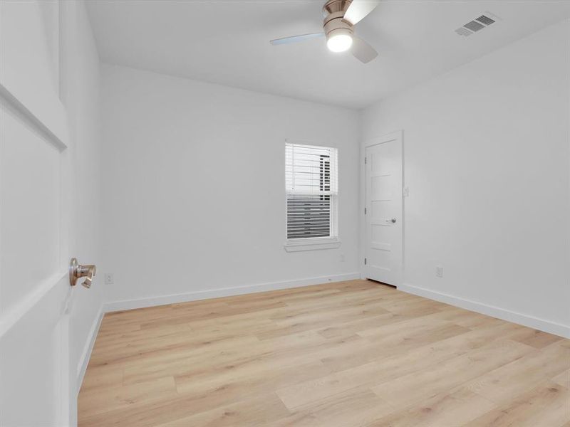 Light hardwood / wood-style floors and ceiling fan